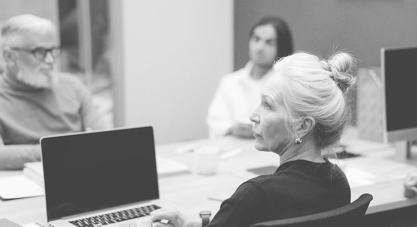 woman sits desk with sign that says no smoking crop u3540